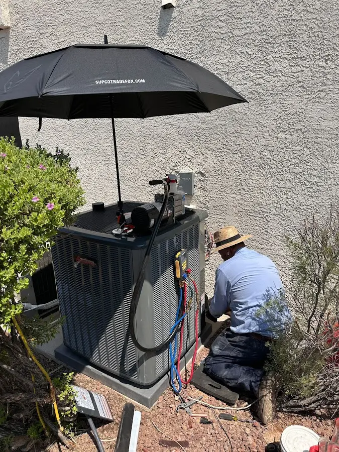 HVAC technician performing outdoor AC maintenance in Port Sheldon