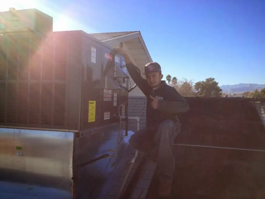 HVAC technician performing AC Tune-Up on a rooftop unit in Port Sheldon
